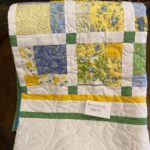 Quilt in yellows, blues, & greens
